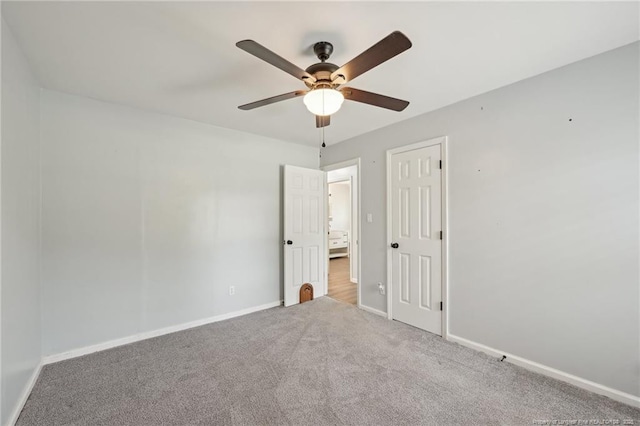 unfurnished bedroom featuring ceiling fan, baseboards, and carpet floors