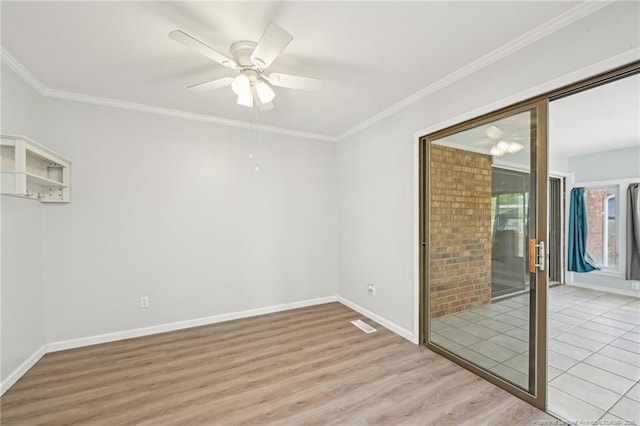 empty room featuring visible vents, a ceiling fan, light wood-style floors, crown molding, and baseboards
