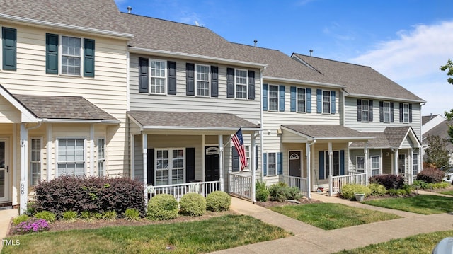 multi unit property featuring covered porch and a shingled roof