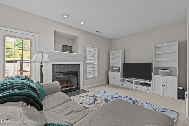 carpeted living area featuring visible vents, recessed lighting, baseboards, and a fireplace