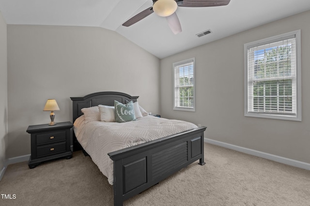 bedroom with baseboards, visible vents, light carpet, and lofted ceiling