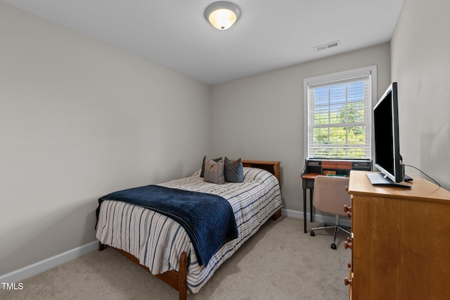 bedroom featuring baseboards, visible vents, and carpet