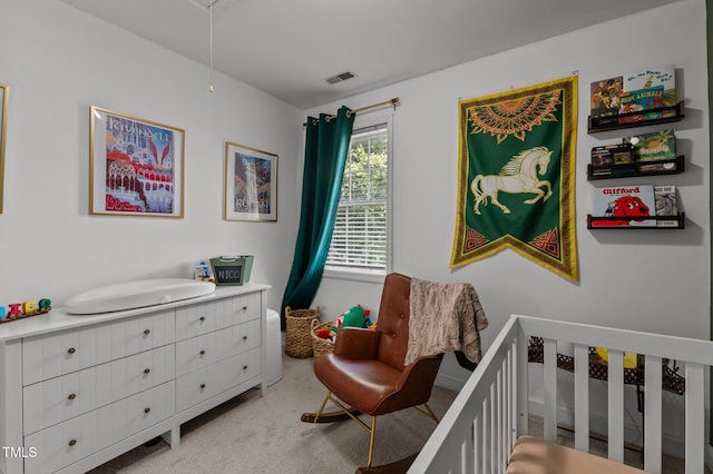 bedroom with attic access, light colored carpet, and visible vents