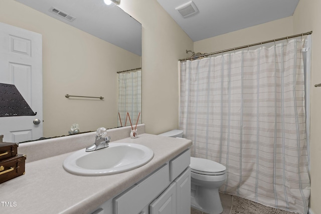 bathroom with vanity, toilet, curtained shower, and visible vents
