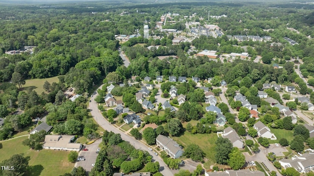 birds eye view of property with a view of trees and a residential view