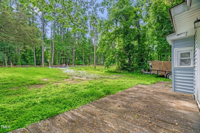 1219 Junction Rd, Durham, NC 27704 - view of grassy yard with a wooden deck and a forest view
