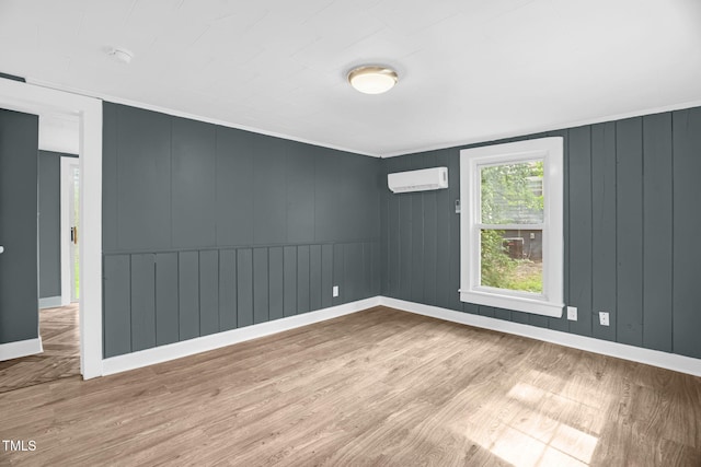 1219 Junction Rd, Durham, NC 27704 - unfurnished room featuring a wall unit AC, wood finished floors, and a smoke detector