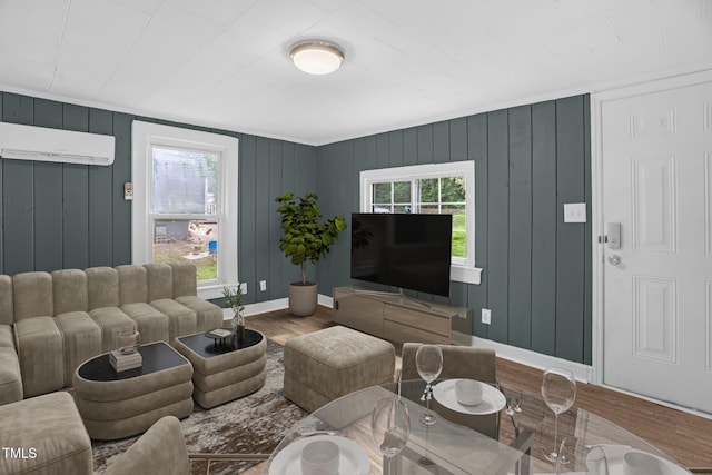 1219 Junction Rd, Durham, NC 27704 - living room with a wall mounted air conditioner and wood finished floors