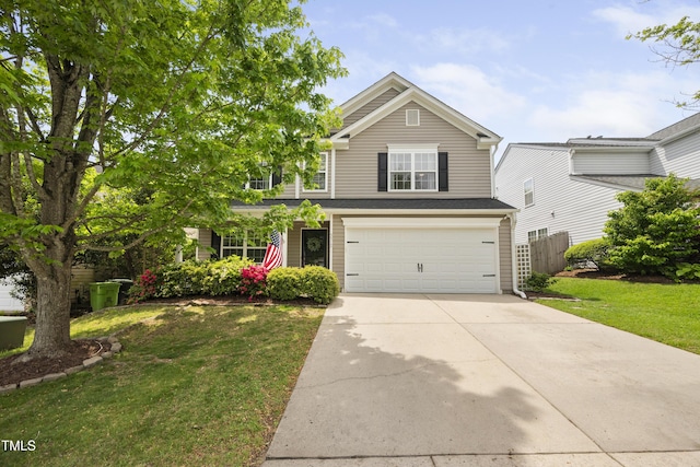 traditional home featuring a garage, fence, driveway, and a front lawn