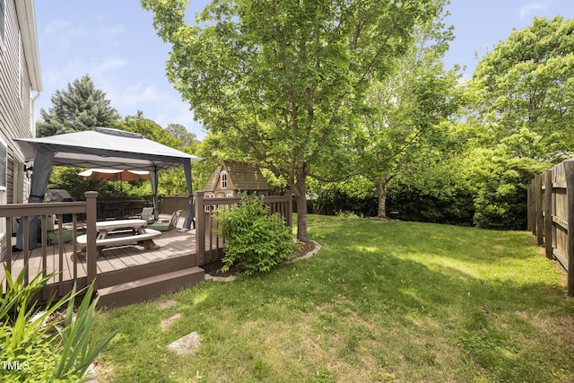 view of yard with fence, a gazebo, and a deck