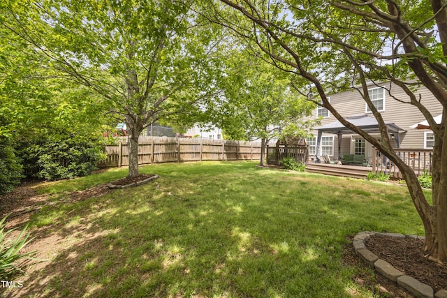 view of yard featuring a deck and fence