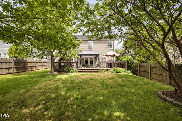 back of house featuring a fenced backyard, a wooden deck, and a yard