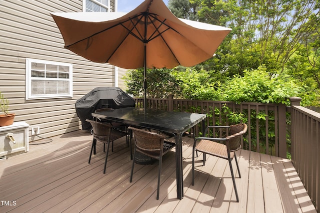 deck with outdoor dining area and a grill