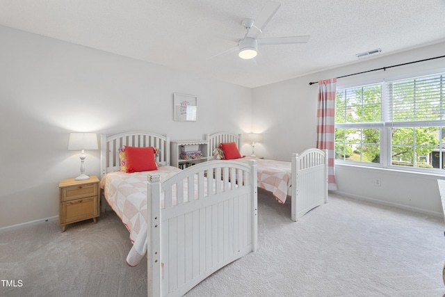 bedroom with light colored carpet, baseboards, visible vents, and a ceiling fan