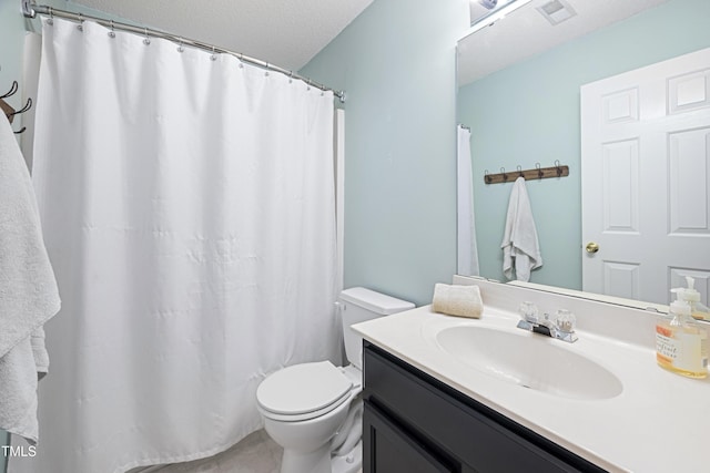 bathroom featuring toilet, a textured ceiling, visible vents, and vanity