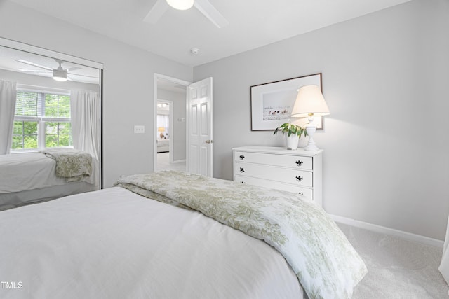 bedroom featuring carpet floors, baseboards, ceiling fan, and a closet