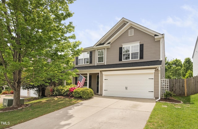 view of front of house with fence, an attached garage, driveway, and a front yard