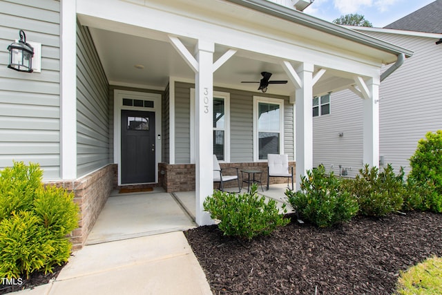 303 Forestview Crest Way, Fuquay Varina, NC 27526 - view of exterior entry featuring a porch, a ceiling fan, and stone siding