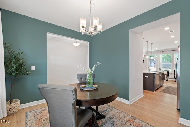 303 Forestview Crest Way, Fuquay Varina, NC 27526 - dining room featuring baseboards, light wood-style floors, a notable chandelier, and visible vents