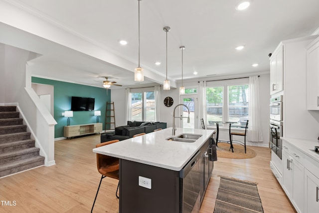 303 Forestview Crest Way, Fuquay Varina, NC 27526 - kitchen with recessed lighting, a center island with sink, a sink, and white cabinetry