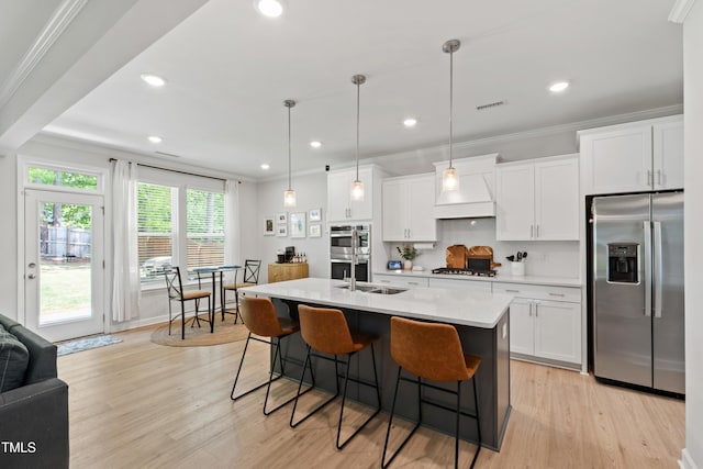 303 Forestview Crest Way, Fuquay Varina, NC 27526 - kitchen with white cabinets, light countertops, premium range hood, stainless steel appliances, and visible vents