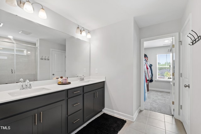 303 Forestview Crest Way, Fuquay Varina, NC 27526 - bathroom with tile patterned flooring, a sink, a stall shower, and double vanity
