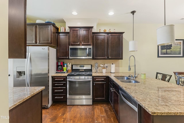 106 Churment Ct, Durham, NC 27703 - kitchen featuring dark brown cabinets, a sink, a peninsula, appliances with stainless steel finishes, and light stone countertops