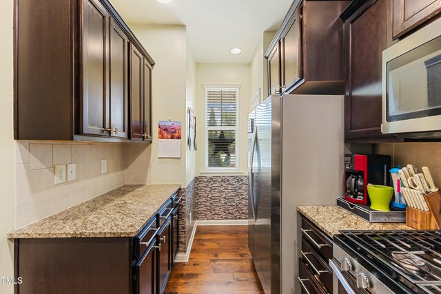 106 Churment Ct, Durham, NC 27703 - kitchen with dark wood finished floors, baseboards, dark brown cabinetry, decorative backsplash, and appliances with stainless steel finishes