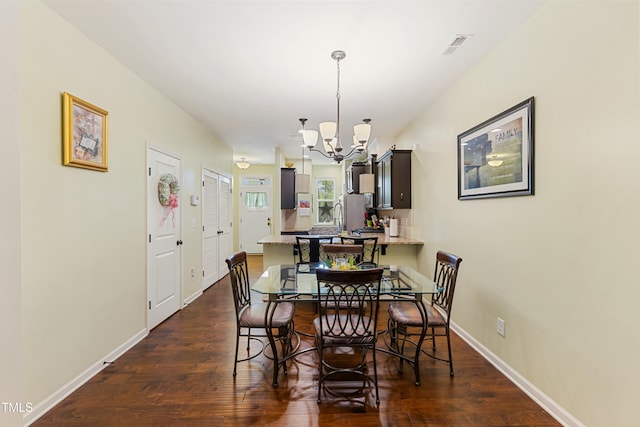 106 Churment Ct, Durham, NC 27703 - dining room featuring baseboards, an inviting chandelier, and dark wood finished floors