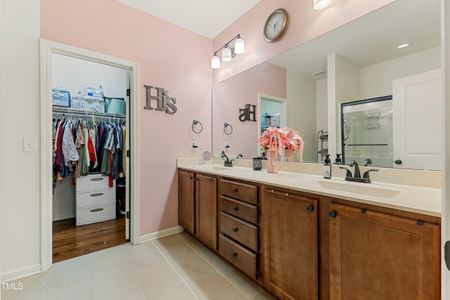 106 Churment Ct, Durham, NC 27703 - full bath featuring a walk in closet, baseboards, a sink, and a stall shower