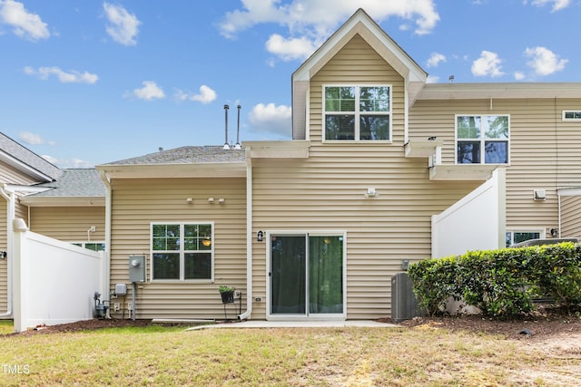 106 Churment Ct, Durham, NC 27703 - back of house featuring a lawn, fence, and central AC