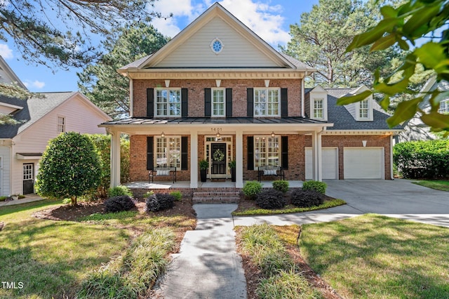 neoclassical home with a porch, driveway, a garage, brick siding, and a front lawn