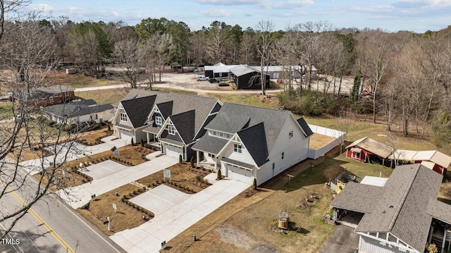 birds eye view of property with a wooded view and a residential view