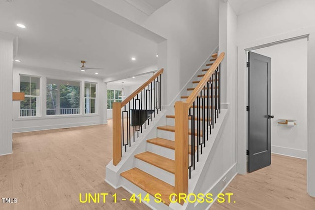 stairs featuring baseboards, a ceiling fan, wood finished floors, and recessed lighting