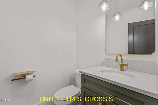 bathroom featuring vanity and toilet