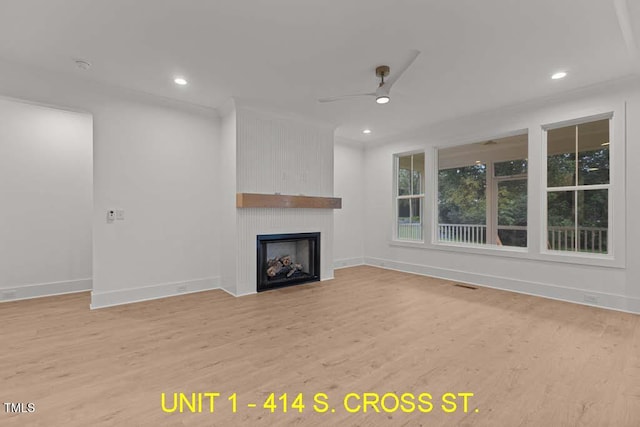 unfurnished living room with recessed lighting, a large fireplace, ceiling fan, and light wood-type flooring
