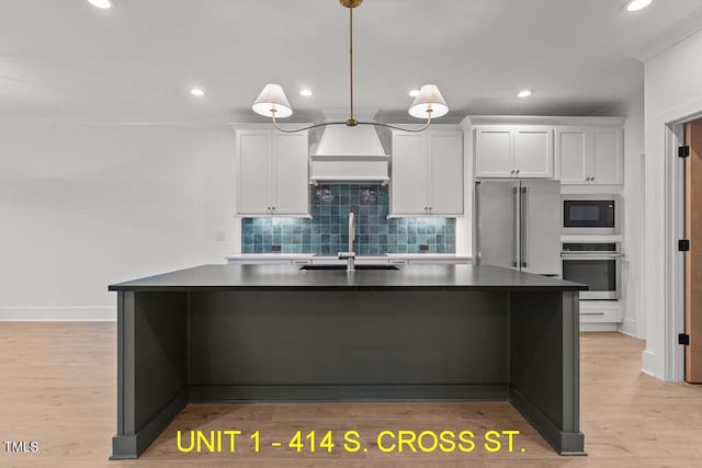 kitchen with dark countertops, appliances with stainless steel finishes, recessed lighting, and a sink