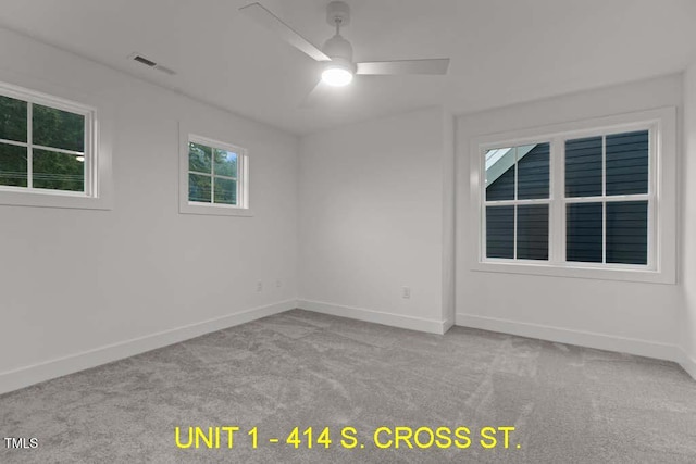 spare room featuring baseboards, ceiling fan, carpet, and visible vents