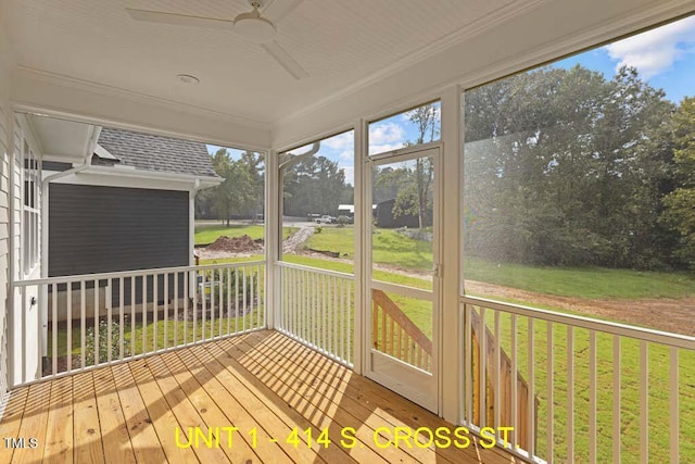 unfurnished sunroom featuring a ceiling fan