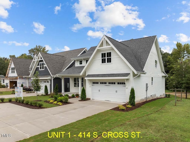 view of front facade featuring an attached garage, roof with shingles, driveway, and a front yard