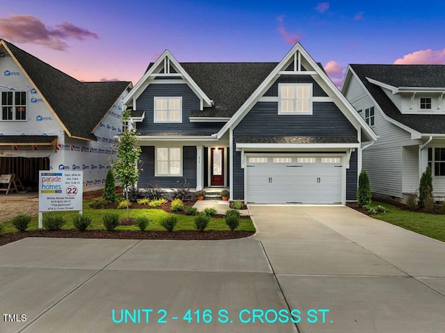 view of front of property with a garage and concrete driveway