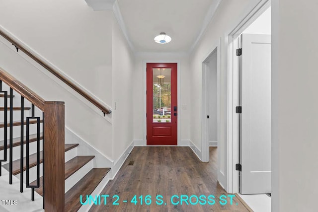 entrance foyer with stairway, baseboards, ornamental molding, and wood finished floors