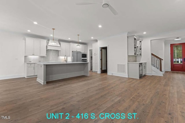 kitchen featuring open shelves, appliances with stainless steel finishes, dark wood finished floors, and tasteful backsplash
