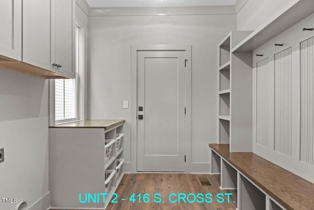 mudroom with wood finished floors