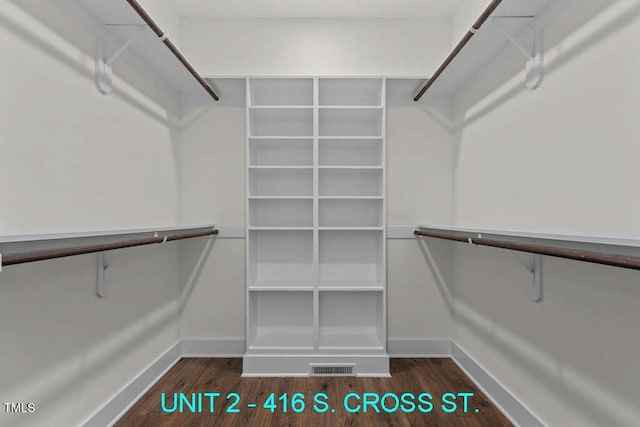 walk in closet featuring visible vents and wood finished floors