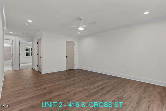 empty room featuring baseboards, a ceiling fan, and wood finished floors