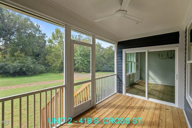 unfurnished sunroom featuring a ceiling fan