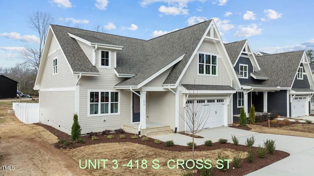 view of front of property with board and batten siding, crawl space, driveway, an attached garage, and a shingled roof