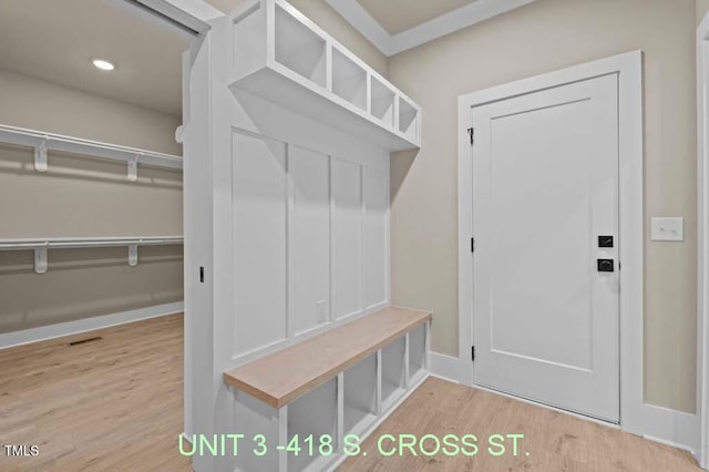 mudroom featuring baseboards and wood finished floors