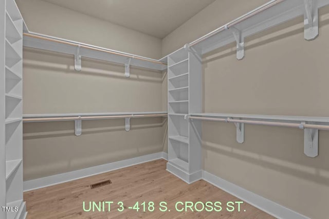 spacious closet with visible vents and wood finished floors